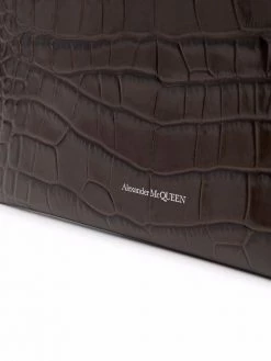 Alexander McQueen skull charm croc-embossed clutch bag